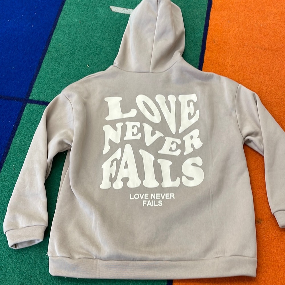 Love never fails hoodie small